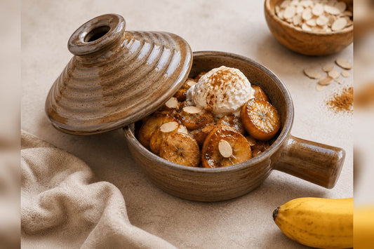 Baked banana dessert with cookies and ice cream served in a ceramic microwave cooker.