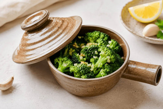 Broccoli in a ceramic microwave cooker with garlic and lemon for an easy microwave side dish.