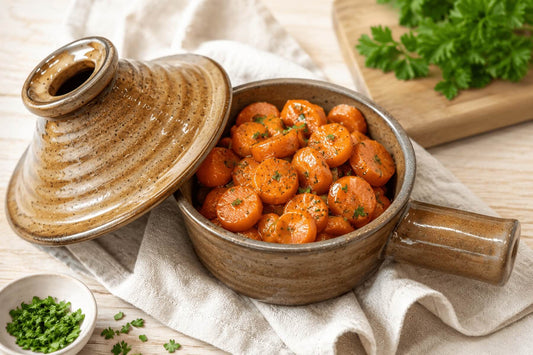 Honey glazed carrots served in a ceramic microwave cooker.