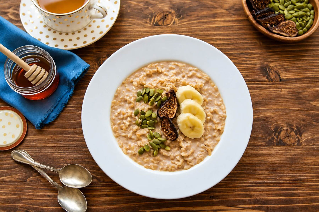 Microwave oatmeal breakfast bowl topped with banana, pumpkin seeds, and dried figs