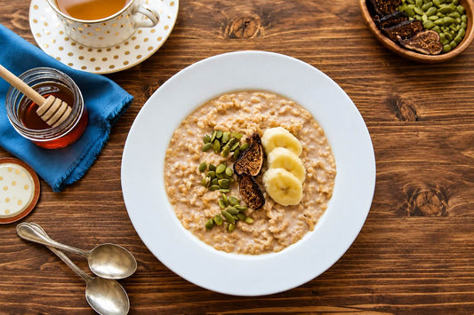 Microwave oatmeal breakfast bowl topped with banana, pumpkin seeds, and dried figs