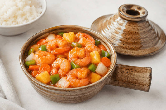 Sweet and sour shrimp with pineapple in a ceramic microwave cooker.
