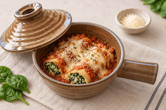 Spinach cannelloni with ricotta baked in a ceramic microwave cooker.
